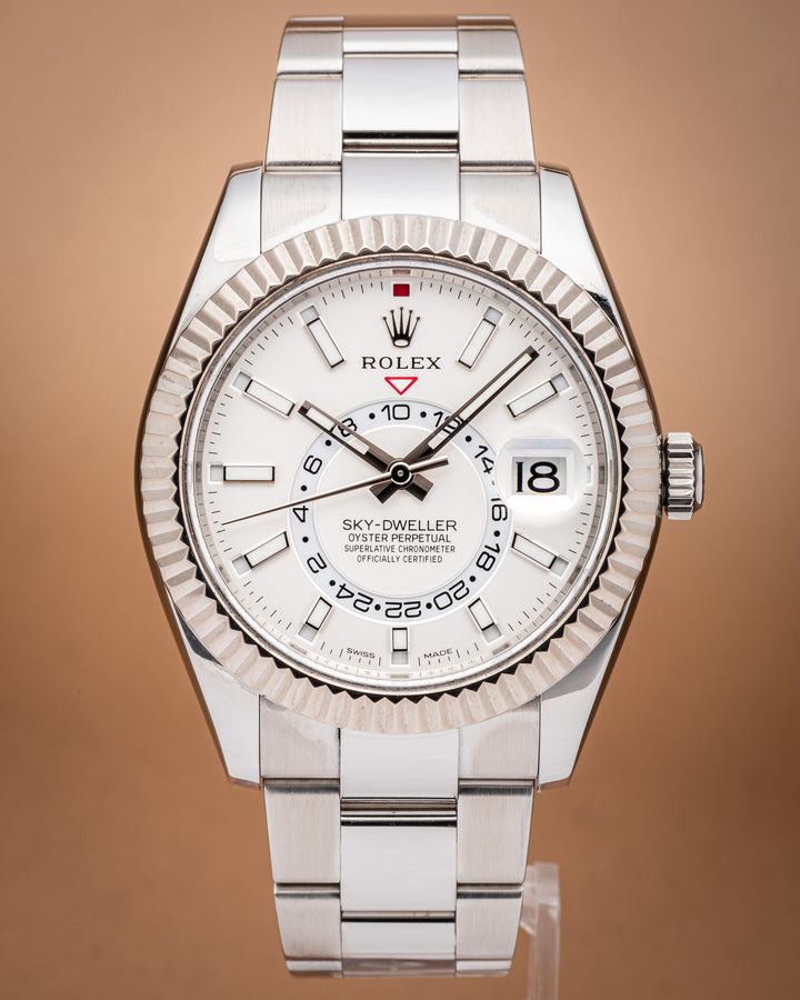 Stainless Steel Rolex Sky-Dweller watch with a white face on a brown background